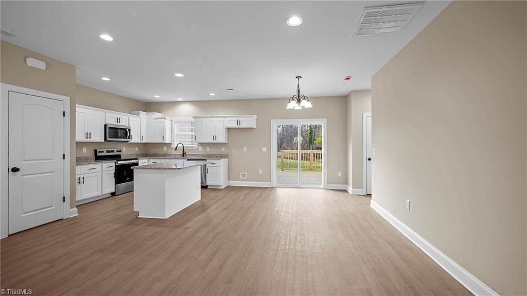 Kitchen with granite island and stainless appliances