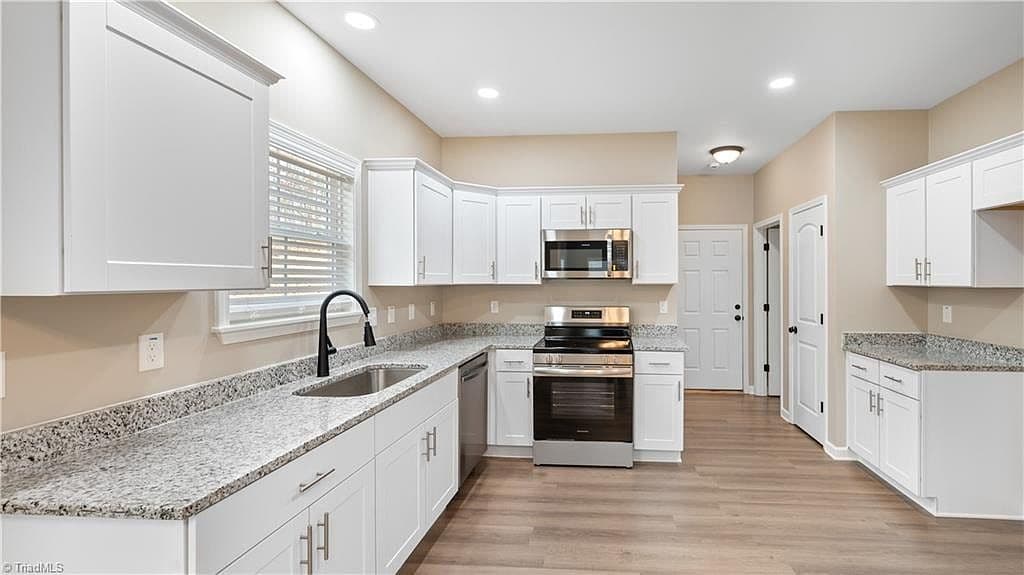 Kitchen with white cabinets and granite counters