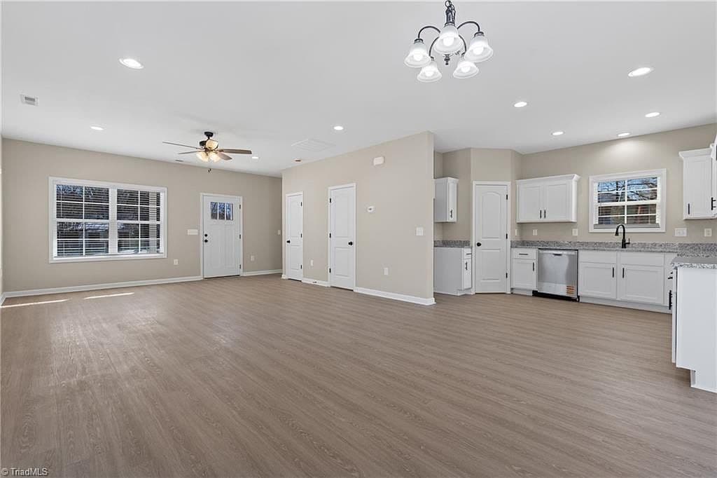 Kitchen with white shaker cabinets and granite