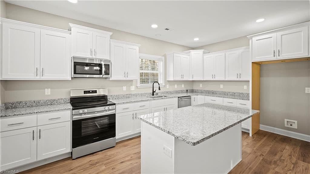 Kitchen with island and granite counters